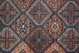 Close-up of Feizy Rawlins rug. Transitional oriental design in brown, red, ivory, and teal. Vintage farmhouse style. Texture