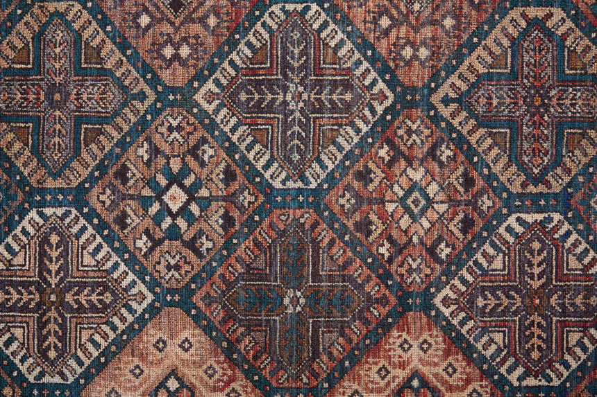 Close-up of Feizy Rawlins rug. Transitional oriental design in brown, red, ivory, and teal. Vintage farmhouse style. Texture