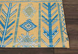 Close-up of Nourison Madera Saffron Tribal rug. Mustard yellow with blue and white geometric tribal pattern.