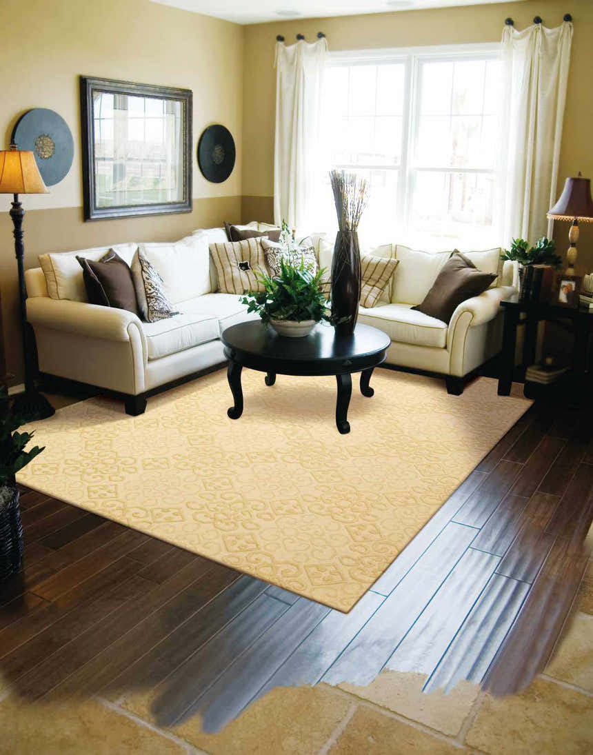 Living room scene with a beige Nourison Ambrose Linen rug, white sectional sofa, and dark wood accents.