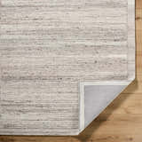 Close-up of the Blenda Beige Area Rug. Hand-tufted wool rug with horizontal beige, charcoal, and light gray striations. Fold