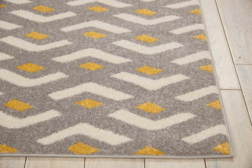 Close up of Nourison Harper Grey Colorful Indoor Area Rug with geometric pattern in gray, cream, and gold.