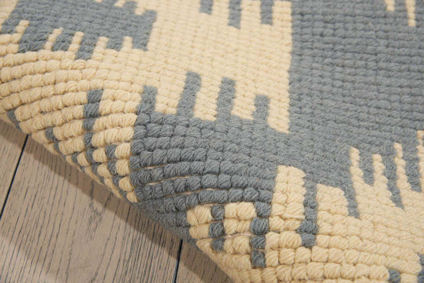 Close up of the Barclay Butera Prism Slate rug showing taupe and slate geometric pattern and wool texture.