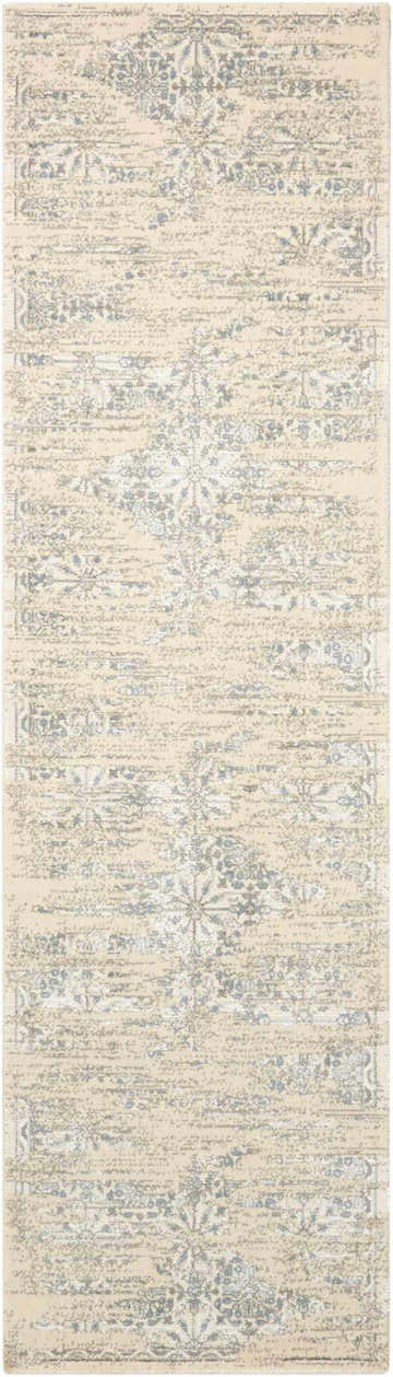 Close-up of Nourison Luminance Bone Vintage rug. Beige rug with distressed blue floral and geometric pattern. Handmade.