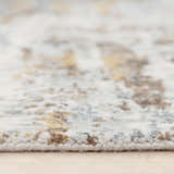 Close-up of the Rizzy JAS732 area rug showing its beige, blue, and brown abstract pattern and textured, machine-woven construction. Pile