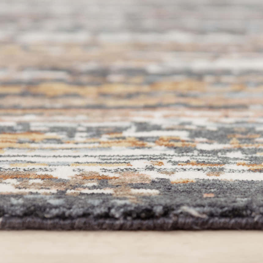 Close up of Rizzy JAS734 area rug showing abstract pattern, beige, dark red, gray, ivory, and rust colors. Pile