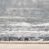 Close-up of the Rizzy JAS740 area rug showing the abstract blue and gray pattern and soft, textured recycled polyester material. Pile