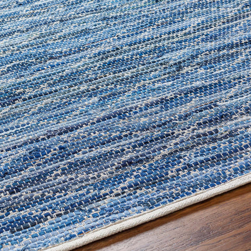 Close-up of the hand woven Gurit Blue Area Rug showing its recycled fabric texture and blue and white stripes. Texture
