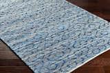 Close-up of the hand woven Gurit Blue & Brown Area Rug showing its recycled fabric texture and contemporary pattern. Corner