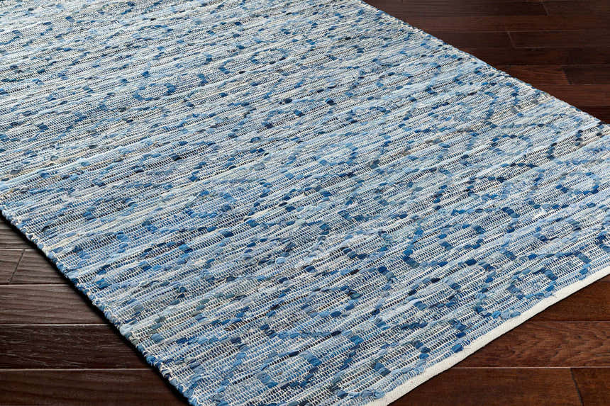 Close-up of the hand woven Gurit Blue & Brown Area Rug showing its recycled fabric texture and contemporary pattern. Corner