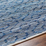 Close-up of the hand-woven Gurit Blue & Brown Area Rug showing its recycled fabric texture and contemporary design. Texture