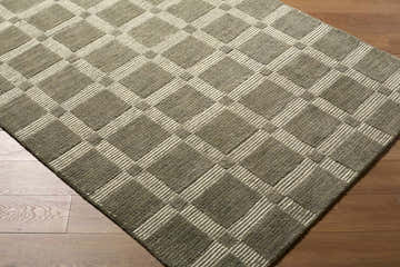 Close-up of the Rofoki Modern Minimalist rug. Hand-tufted wool rug in stone gray and ivory with a geometric plaid pattern. Corner