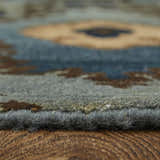 Close-up of the hand-knotted Feizy Amzad rug. Blue, gray, and tan wool fibers show the ikat pattern and texture. Pile