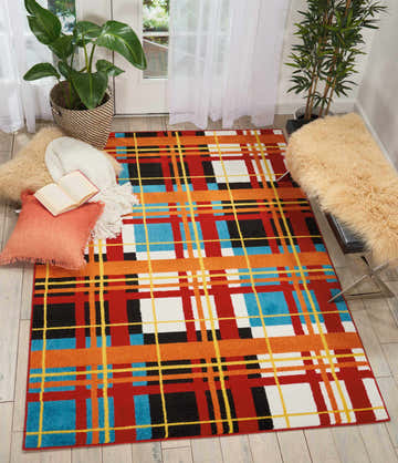 Bright entryway with Nourison Oakdale Red Colorful rug, plants, and a bench with a sheepskin throw.