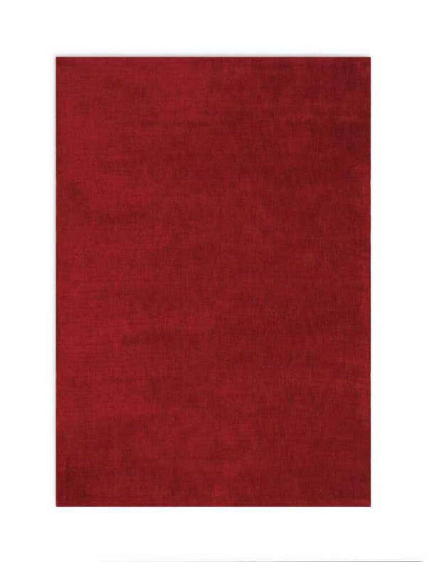 Close-up of the Calvin Klein L.A. Burgundy rug. Solid, deep red color with a subtle texture. Mid-century modern style.