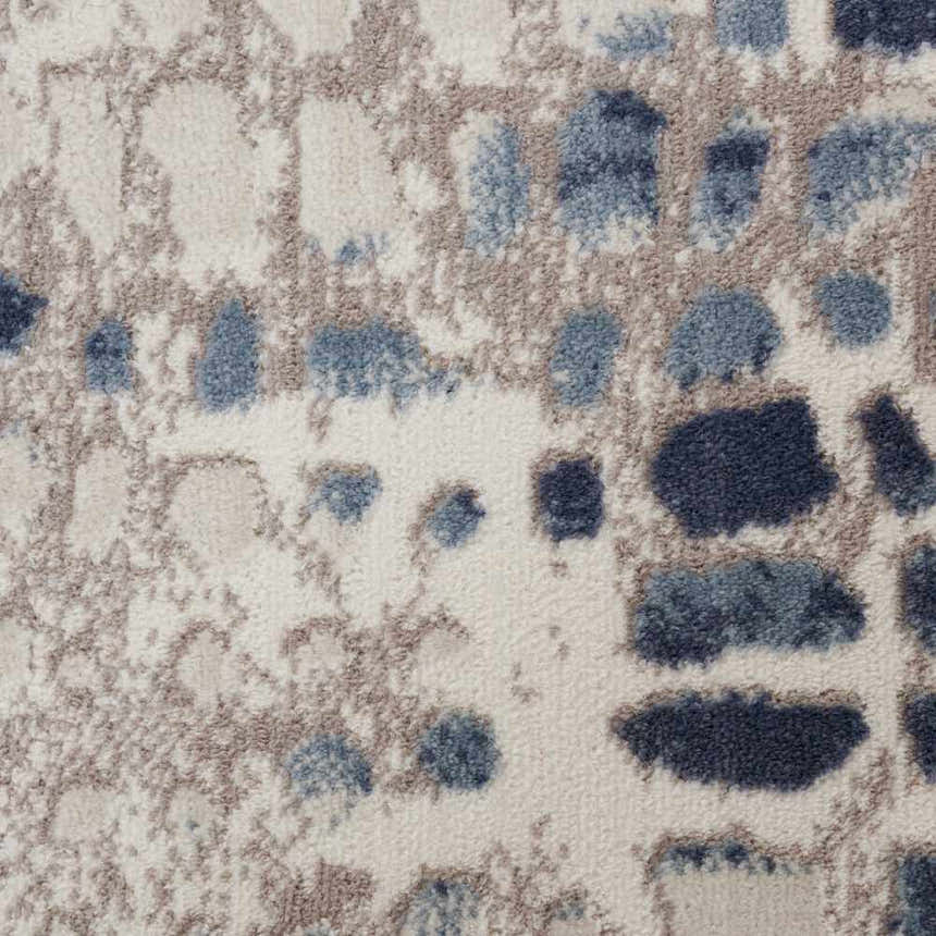 Close-up of Nourison Urban Decor Ivory/Grey rug. Abstract pattern with ivory, grey, and blue tones. Soft texture.