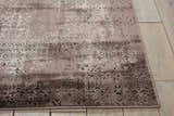 Close-up of Nourison Karma Ash Vintage Area Rug showing ash tones and distressed floral pattern on wood floor.