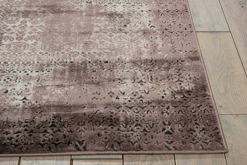 Close-up of Nourison Karma Ash Vintage Area Rug showing ash tones and distressed floral pattern on wood floor.