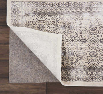 Close-up of the Nourison Basic Loc Non-slip Pad Area Rug showing gray floral pattern and non-slip backing.