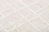 Close-up of the ivory Rizzy JZZ973 area rug. Features a hand-tufted, contemporary square pattern and wool texture. Texture