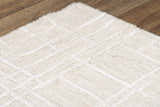 Close up of the ivory Rizzy JZZ973 area rug, a hand-tufted wool rug with a subtle geometric pattern. Texture