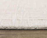 Close-up of the ivory Rizzy JZZ973 area rug showing its wool texture and subtle geometric pattern. Pile