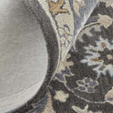 Close up of the Feizy Rylan Taupe/Blue/Ivory Area Rug showing wool texture, floral pattern, and cotton backing. Fold