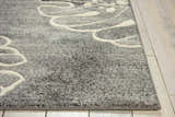 Close-up of the Nourison Maxell Grey rug. Modern design with a gray base and raised white floral pattern. Soft texture.