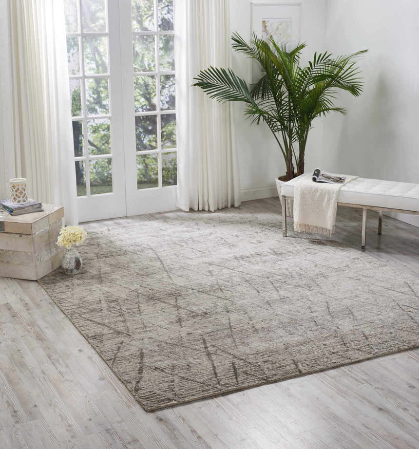 Bright living room with a sandstone Nourison OCEAN Stone rug, white bench, and French doors.