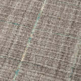 Close up of the Rizzy KIK691 area rug showing its gray wool texture and subtle blue grid pattern. Texture