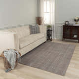 Living room scene with Rizzy KIK691 area rug in gray. Farmhouse style with a cream sofa, wood cabinet, and light wood floors. Roomscene-Rectangle