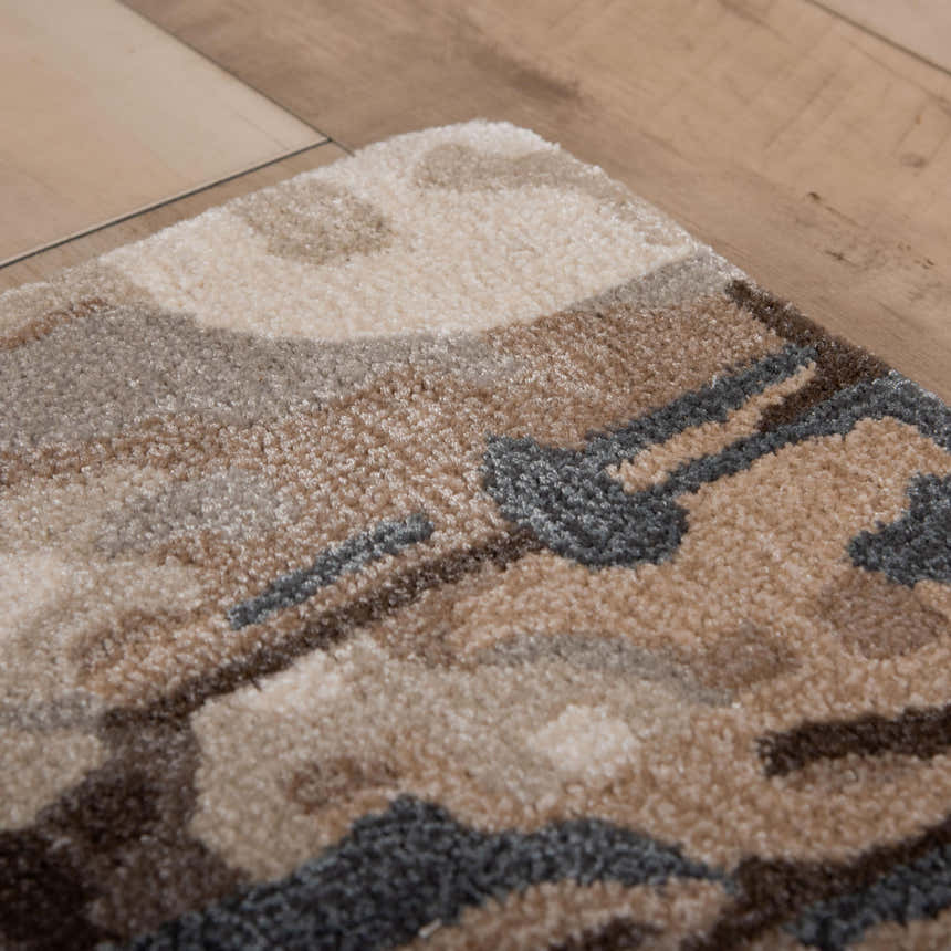 Close-up of Rizzy KIN533 area rug. Beige, charcoal, and brown contemporary pattern. Hand-tufted wool and tencel texture. Fold