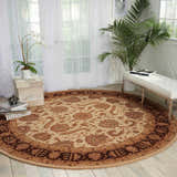 Bright room scene with a round Nourison Heritage Hall Beige Persian rug, white bench, and sheer curtains.