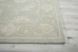 Close up of the Nourison Zephyr Light Taupe rug showing its wool texture and ivory floral pattern.