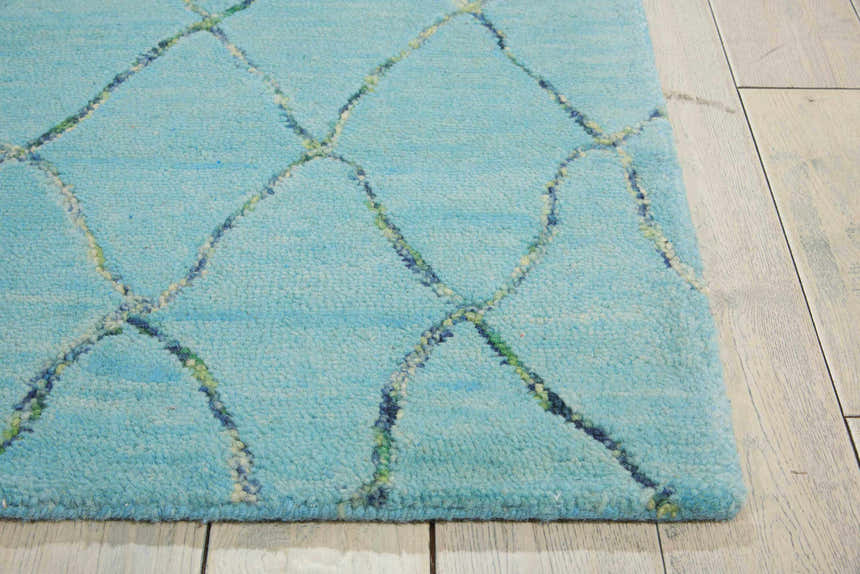 Close up of the Barclay Butera Intermix Wave rug showing the wool texture and wave pattern in blue, green, and white.