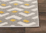 Close-up of Nourison Harper Grey Colorful rug. Features a gray, white, and yellow geometric design.