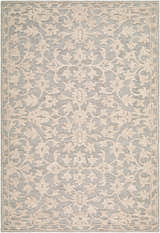 Close-up of the Hiromi Cugydu rug. Hand-tufted wool rug in beige, cream, and taupe with a traditional floral pattern. Design-Rectangle-576