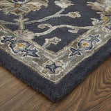 Close up of the Feizy Prescott rug. Blue, gray, and silver floral pattern on a hand-tufted wool rug. Corner