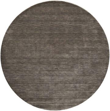 Close-up of a round Feizy Luna Modern Solid Area Rug in brown and taupe, showing the hand-woven wool texture. Design-Round