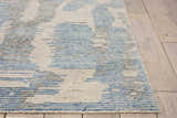 Close-up of the light blue Nourison Ellora rug. Handmade rayon rug with a modern abstract pattern and textured feel.