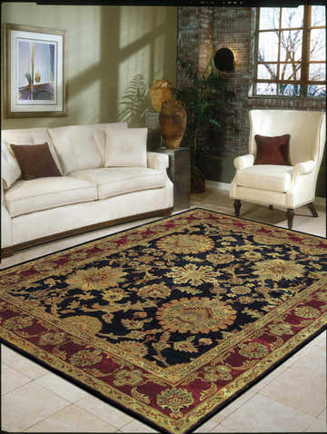 Living room with ivory sofa and Nourison Jaipur Black Persian rug.