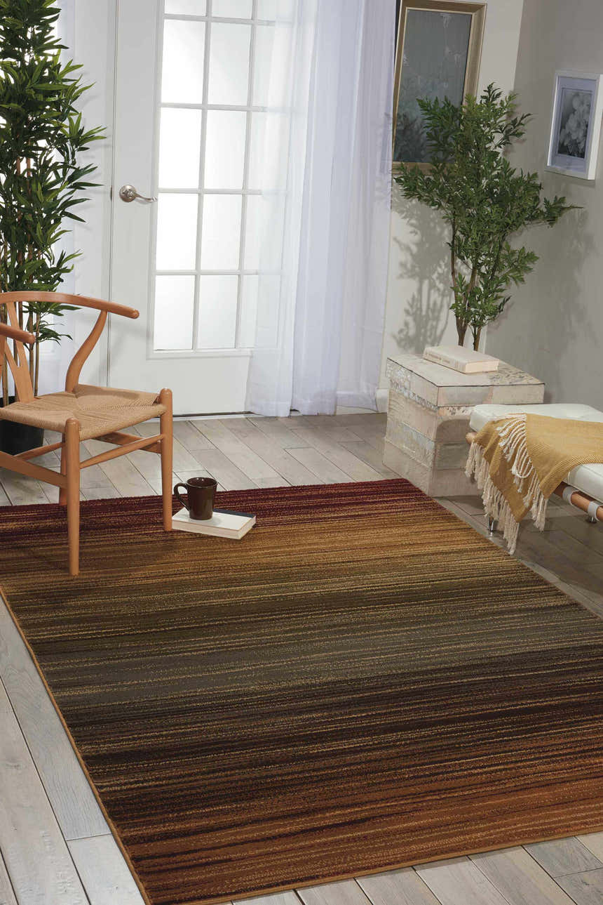 Entryway with Nourison Paramount Multicolor Painterly Rug, wood chair, white bench, and plants.