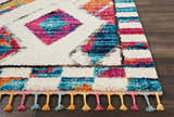 Close-up of Nourison Nomad Ivory Multicolor Tribal rug. Features diamond and square patterns, plus colorful tassels.