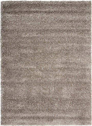 Close-up of the Nourison Amore Stone Shag Indoor Area Rug, showing its plush sandstone color and soft, textured shag pile.