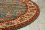 Close-up of the round Nourison Living Treasures Aqua rug showing its floral pattern and aqua, red, and beige colors.
