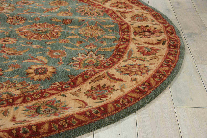 Close-up of the round Nourison Living Treasures Aqua rug showing its floral pattern and aqua, red, and beige colors.