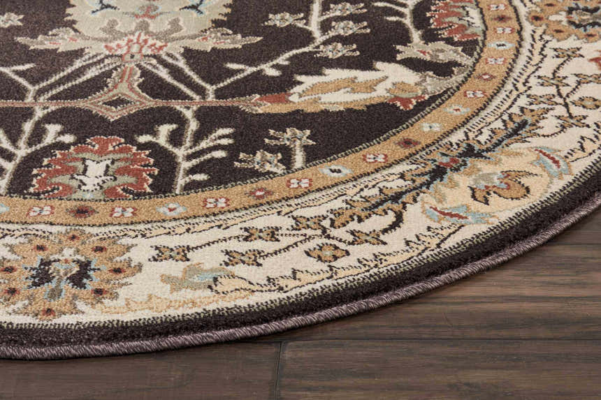 Close-up of the round Nourison Walden Bistre Vintage Area Rug, showing its floral pattern and bistre, beige, and brown colors.