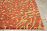 Close-up of the Nourison Tahoe Rust/Beige rug, showcasing its abstract pattern and wool texture. Modern design.