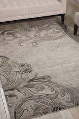 Living room scene with a Nourison Maxell Graphite rug featuring a gray swirling, contemporary pattern.