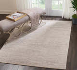 Entryway with a bench and the Nourison OCEAN Sand modern rug on dark wood floors.